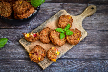 Home made  oven baked meatballs  from  chicken and vegetables and french potato  fries on  wooden background.Bifteki, or spicy meatballs 