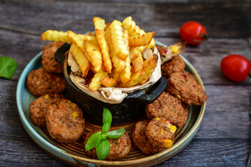 Home made  oven baked  mini meatballs  from  chicken and vegetable on  wooden background
