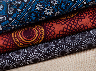 Shweshwe, an iconic printed cotton fabric from South Africa. blue, orange and brown prints