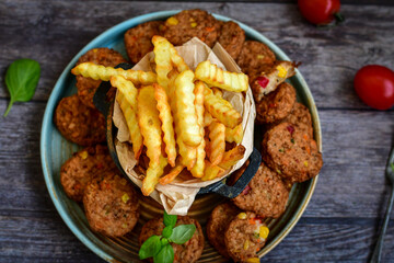 Home made  oven baked  mini meatballs  from  chicken and vegetable on  wooden background