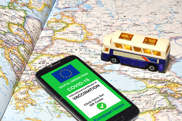 The digital green pass of the European Union on smartphone with a model of pulmann over a...