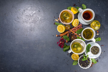 Various tea ball bombs. Assortment of different tea balls with dried tea, cups, lemon and mint, top...