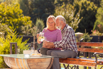 Senior couple drinking lemonade in the backyard - Powered by Adobe