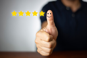 Customer experience satisfaction concept. customer hand with thumb up Positive emotion smiley face...