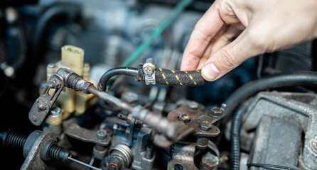Fototapeta na wymiar diagnostics of the car's fuel system, checking fuel hoses for leaks.