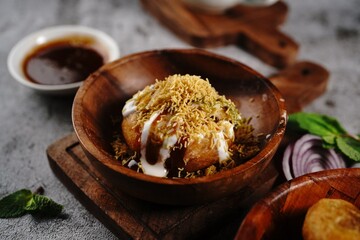 Raj Kachori or Kachouri - Indian deep fried snack stuffed with potatoestopped with yogurt cutneys and sev - obrazy, fototapety, plakaty