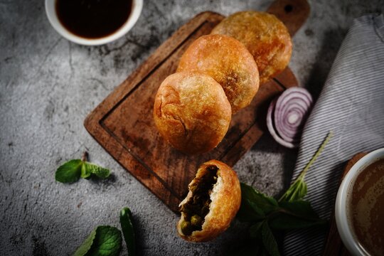 Kachori or Kachouri - Popular deep fried Indian snack served with chutney, selective focus