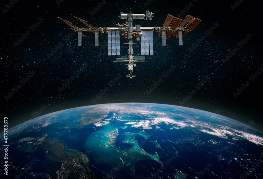 Wall mural the international space station orbiting planet earth. scientific space exploration using a space st