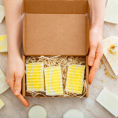 Gift box with set of natural soap in female hands. DIY soaps kit. Many various homemade bar soaps....