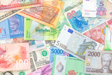 Fototapeta na wymiar Background from paper money of different countries. Dollar, euro banknotes and others. View from above.