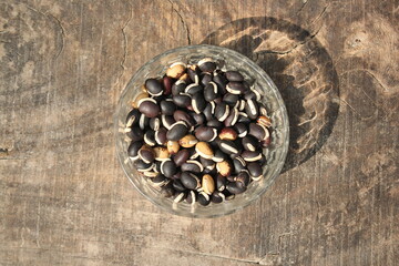 Mixed color dry beans on a glass bowl