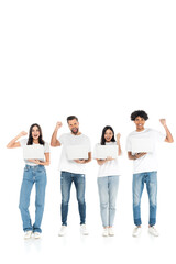 full length view of happy multiethnic friends with laptops showing triumph gesture on white.