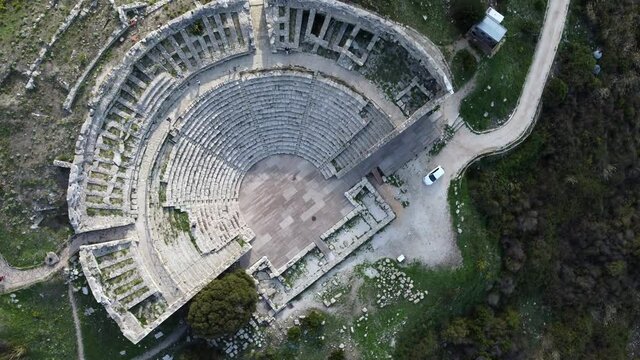 Rotating Birds-eye view of an Ancient Greek Theater with its Stage and Ruins