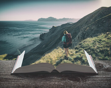 Girl hiker with backpack on the pages of an open book