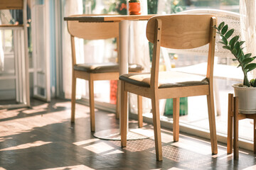 wooden table chair, Wooden table with houseplant in light living room, Esstisch mit Blumen in Altbauwohnung, chair at table with computer monitor in bright home office interior with poster. Real photo