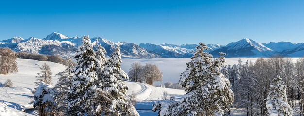 Winter view of the Champsaur Valley with Ecrins National Park mountain peaks in the distance....