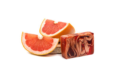 Soap bar with grapefruit slice on wooden background