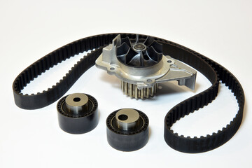 The timing belt, rollers and water pump stands on a white background
