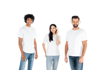 happy multiethnic men and asian woman in headphones looking at camera isolated on white.
