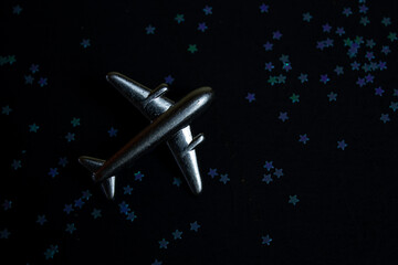 a toy metal airplane on a dark background.