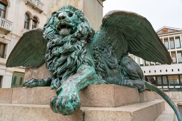Winged lion statue with green copper patina in Venice on Campo Manin