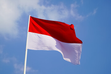 The single large red and white Indonesian flag flutters in the strong wind ahead of the 77th Independence Day of the Republic of Indonesia.