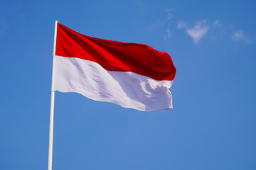 The single large red and white Indonesian flag flutters in the strong wind ahead of the 77th Independence Day of the Republic of Indonesia.