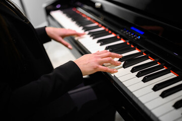 Fototapeta na wymiar Close up of a musician playing a piano keyboard
