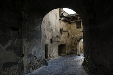 Fototapeta na wymiar Paved alley the Sighisoara Old Town or Citadel (fortress).