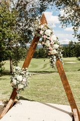 Wedding triangular arch in boho style Triangular wooden arch with the composition of roses and ...