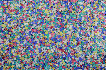 Fototapeta na wymiar Texture formed by confetti of various colors, pink, green, blue, yellow and white ideal for party backgrounds and graphic resources