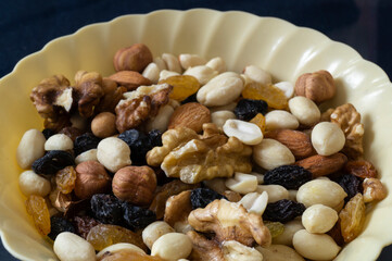 The mixture of nuts is in a yellow plate