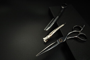 professional stylist tools lie on a black background