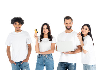 smiling woman holding credit card near man with laptop and interracial friends isolated on white.