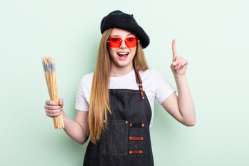redhair woman feeling like a happy and excited genius after realizing an idea. artist concept