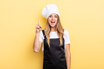 pretty woman feeling like a happy and excited genius after realizing an idea. chef concept