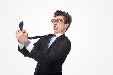 Funny stressed businessman choking himself with tie