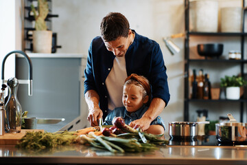 Father and daughter chopping vegetables