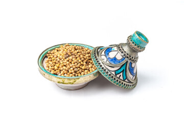 Coriander seeds in a mini Moroccan tajine