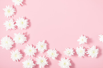 Obraz na płótnie Canvas Beautiful flowers composition. Spring minimal concept. White flowers on pastel pink background. Valentines Day, Happy Women's Day. Flat lay, top view, copy space, banner