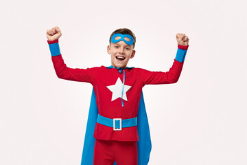 Strong superhero celebrating victory in studio