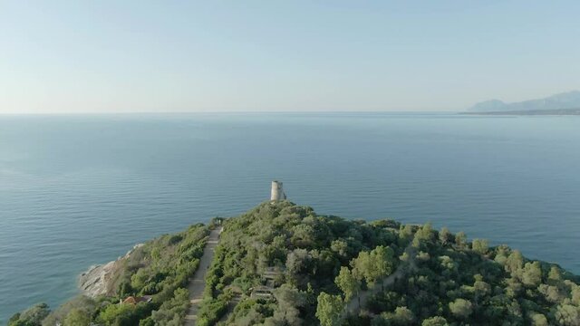 Aerial view of San gemiliano tower, Sardinia travel destination summer holiday in Italy. Drone fly above rock cliff formation