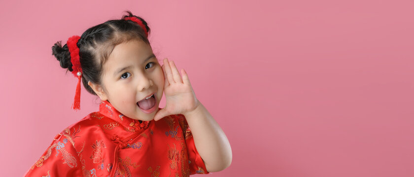 Smiling cute asian little girls in red chinese traditional dress.Happy Chinese new year concept.