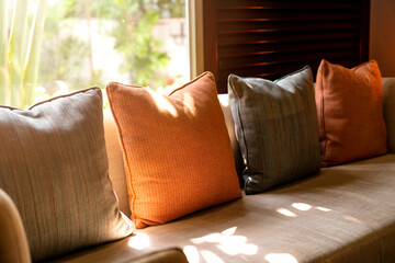 colorful  pillow cushion arrange on sofa bed bench booth window side with background of wooden...