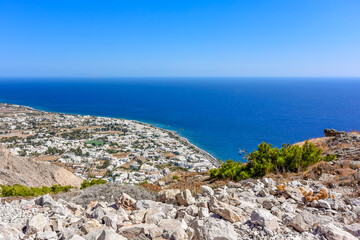 Kamari village and resort, aerial view from Messavouno (Mésa Vounó) mountain on Santorini island, Greece.