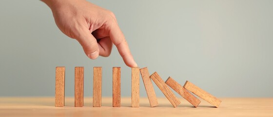 Risk and Strategy in Business, Hand Stopping wooden block domino business crisis effect or risk...
