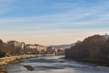 Scenic view of Lungo Po Luigi Cadorna riverside with Murazzi bank, the river park of Borgo Po district and the Basilica of Superga on the hilltop in winter, Turin, Piedmont, Italy