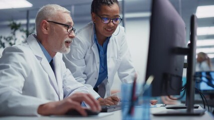 Medical Hospital: Two Doctors Talk and Use Computer, Diagnose and Tests Information, Finding Cure and Solution. Health Care Clinic Research with Team of Diverse Contemporary Professionals Working - Powered by Adobe