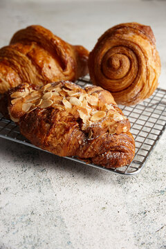Close up of assorted pastries on a cooling rack on marble background