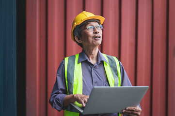 Portrait Senior Chinese business owner inspecting shipping containers to export products to foreign...